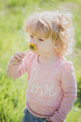 child with dandelion