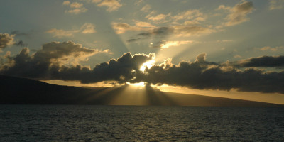 sun rays behind cloud