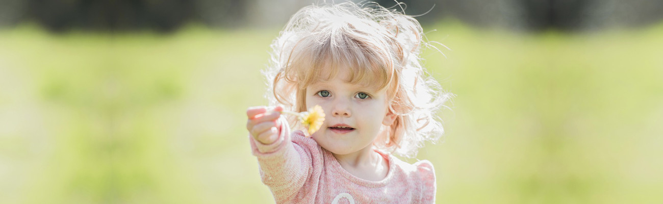 child with dandelion