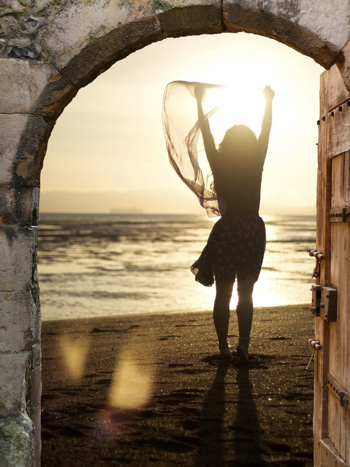 girl open arms in sunrise