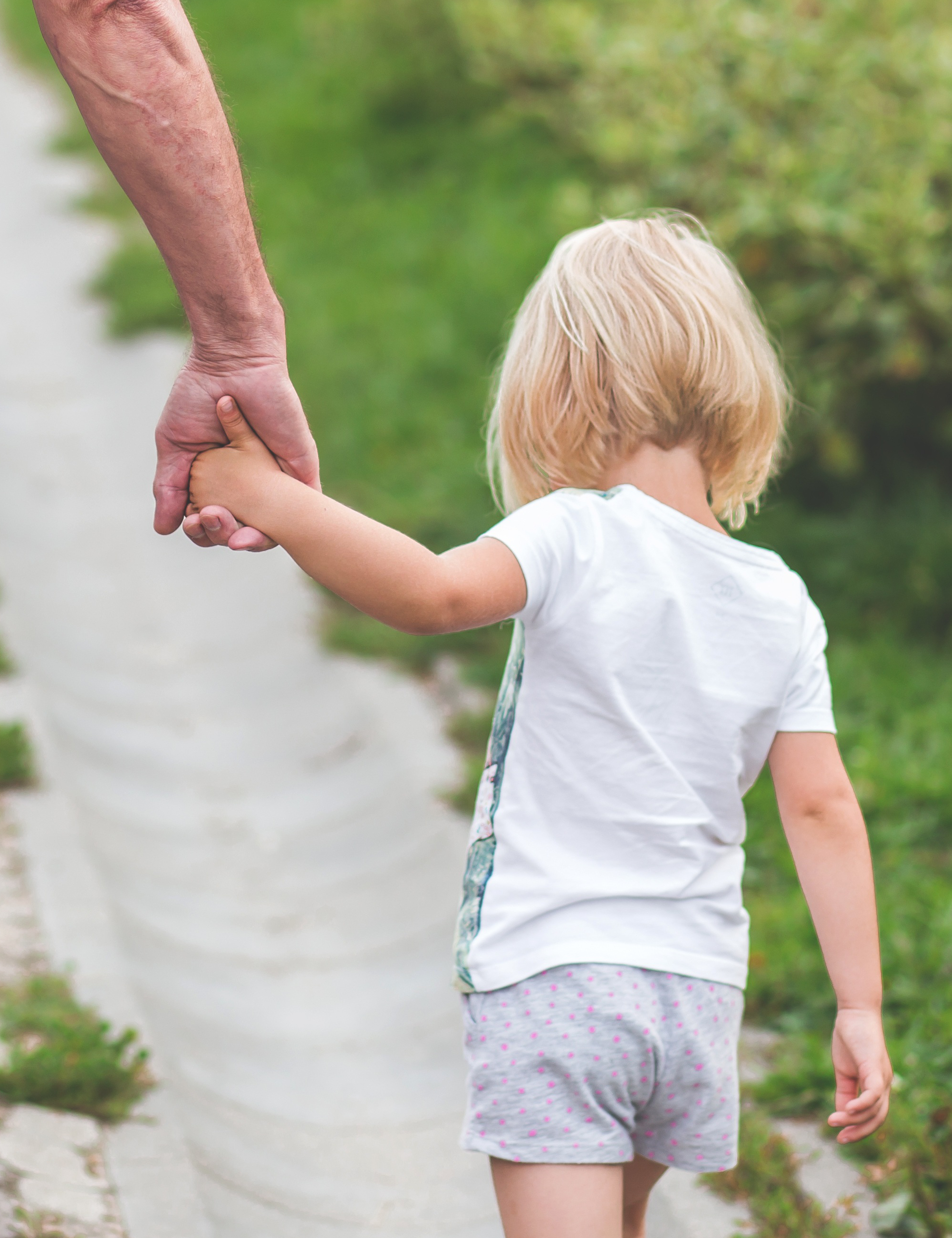 girl holding dad's hand